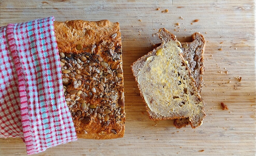 Easy no-knead grain bread sliced with butter
